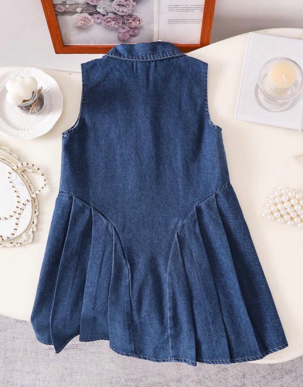 Vestido vaquero azul sin mangas vista frontal con botones dorados y bolsillos